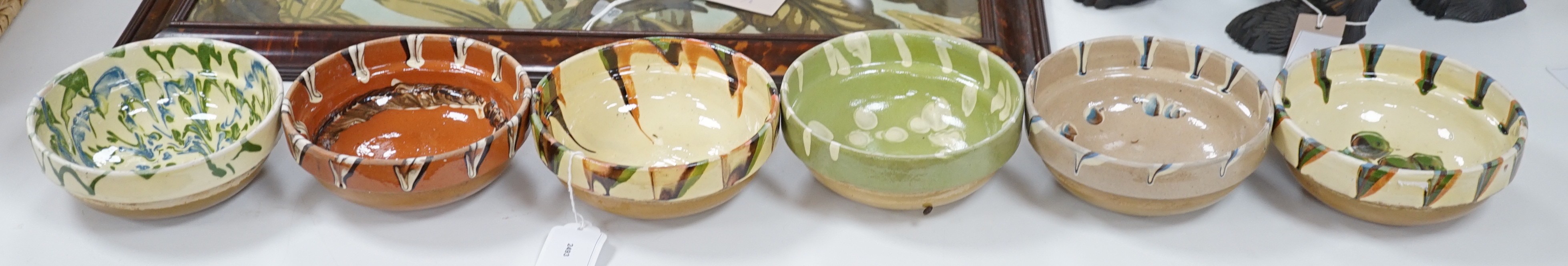 A group of six continental pottery slip decorated bowls, 16 cms diameter